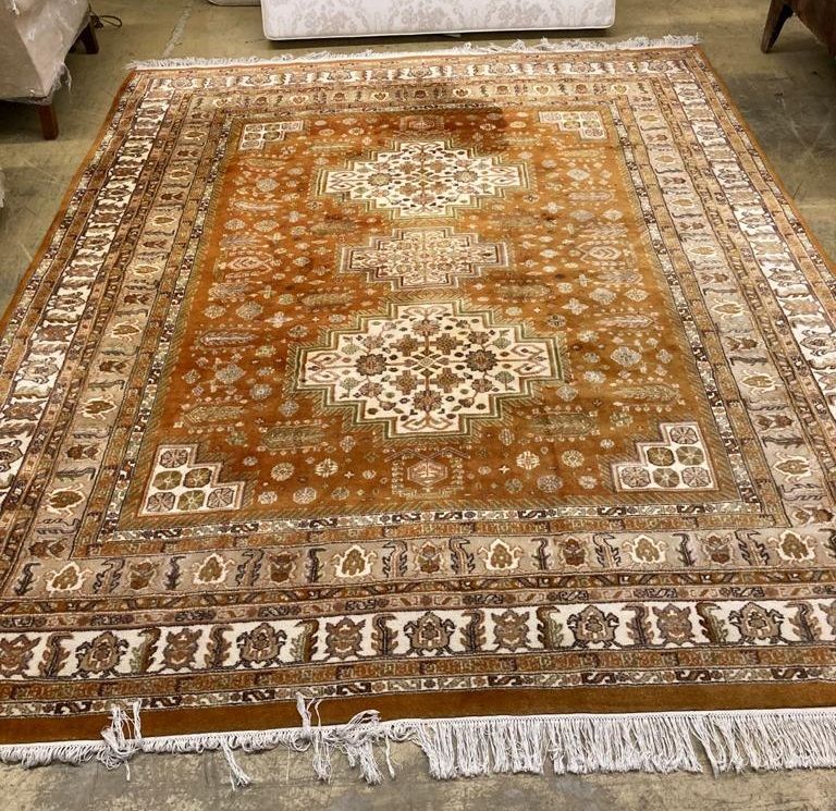 An Indian Kazak style red ground carpet, 300 x 247cm